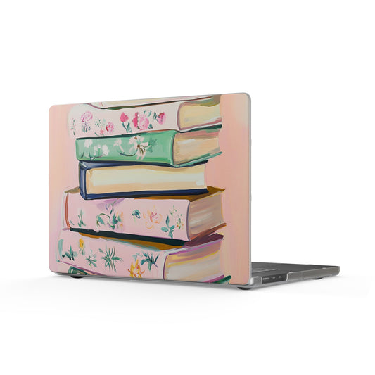 Laptop featuring a matte hard case with a pastel, vintage-style floral stack of books illustration, similar to designs available via the Mai Autumn Decor Store