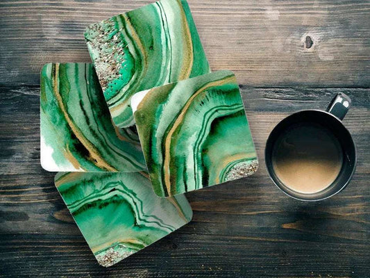 Set of 4 green agate watercolor coasters on wooden table with coffee cup